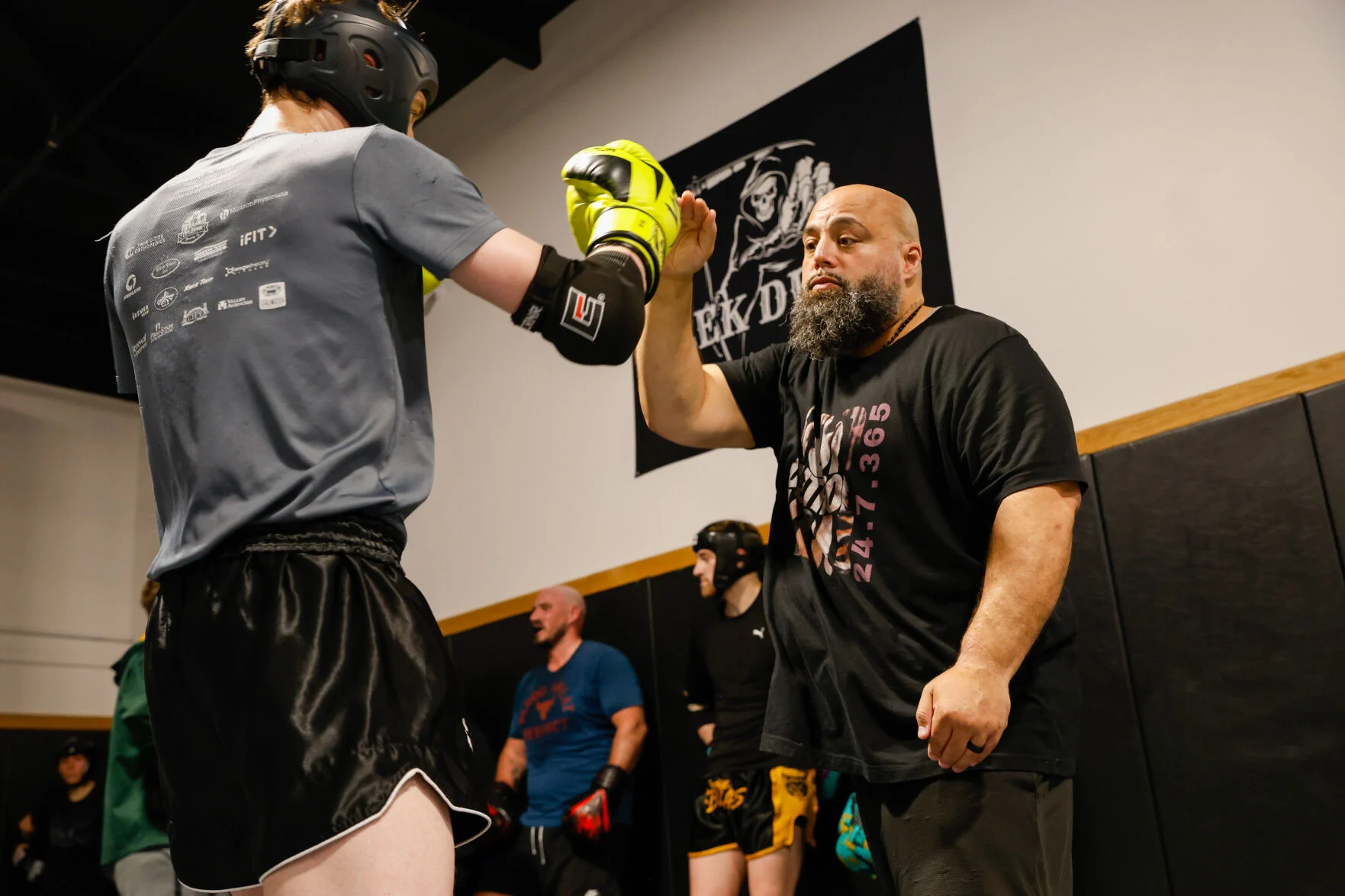 Mark “ShaH” Evans coaching a Muay Thai student during class.
